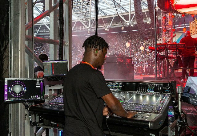 Duriel Mensah, Burna Boy’s primary monitor engineer, mixes the lead vocal, core band, and horn section on a DMI-KLANG equipped DiGiCo Quantum7 console (photo credit: Tosin Orojinmi, Doxa Studio)